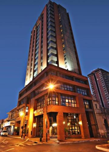 a tall building on a city street at night at Sabe Center in Asuncion