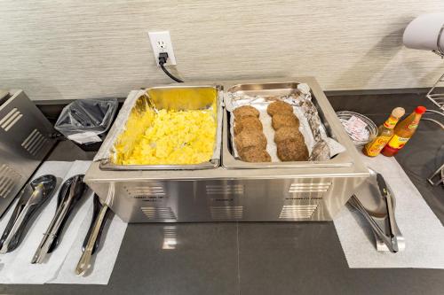 two trays of food on top of a counter at Orangewood Inn & Suites Kansas City Airport in Kansas City