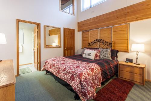 a bedroom with a large bed with a wooden headboard at Val d'lsere # 21 in Mammoth Lakes