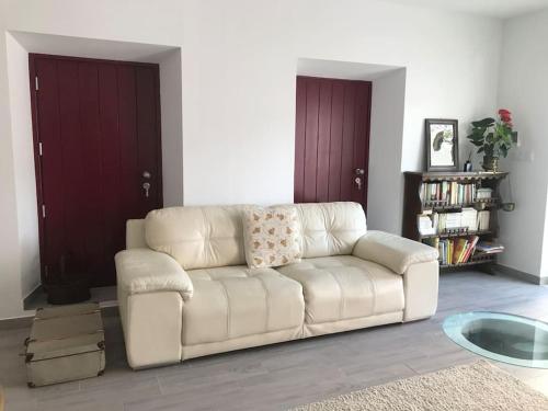 a white couch sitting in a living room at Casa do Reguengo 1 in Estremoz