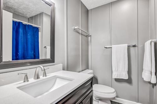 a white bathroom with a sink and a toilet at Pelican's Perch in Waynesville