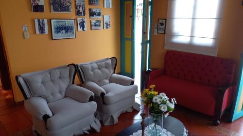 a living room with two chairs and a couch at Casa Posada Maestro Carlos Aranguren in Duitama