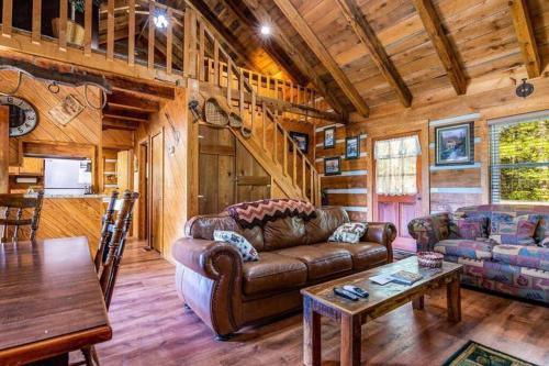 a living room with a couch and a table in a cabin at R&R Retreat in Sunshine
