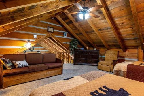 a living room with a couch and a bed in a cabin at R&R Retreat in Sunshine