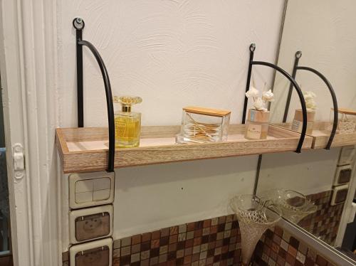 a shelf on a wall with some items on it at Villa des Chats in Calais