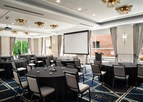 a conference room with tables and chairs and a projection screen at Hyatt Place Knoxville/Downtown in Knoxville