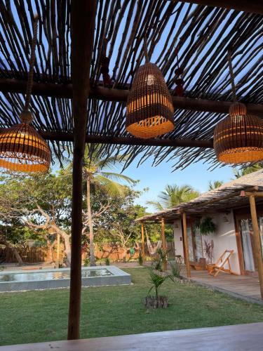 a view of a house with two hanging lights at Casa Rosa Atins in Atins