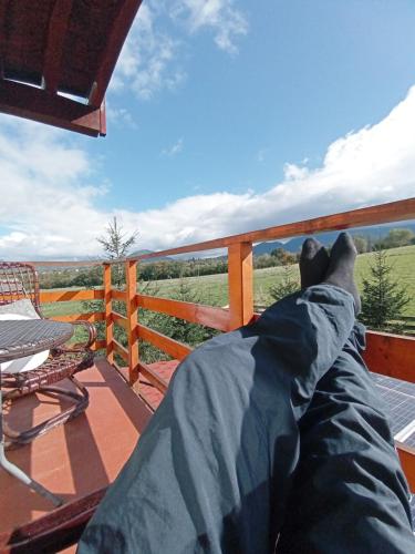 a person laying on a deck with their legs up at Vila Rem in Bran