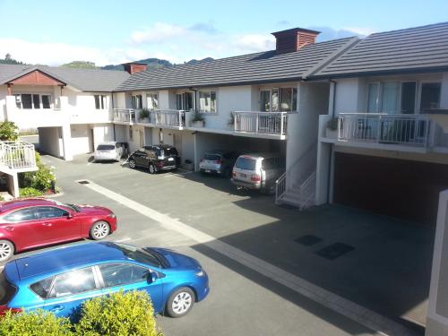 a parking lot with cars parked in front of houses at Cedar Grove Motor Lodge in Nelson