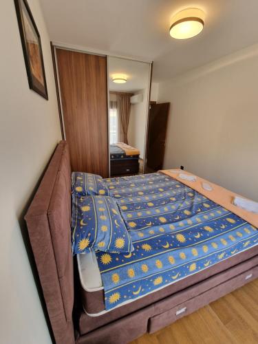 Un dormitorio con una cama con un edredón azul. en Fantastic new centre apartment, en Podgorica