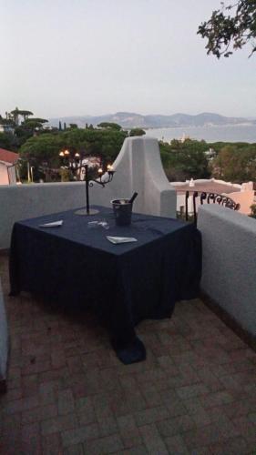 a black table with a vase on it on a balcony at FONDAZIONE VILLA POINT ONLUS in San Felice Circeo