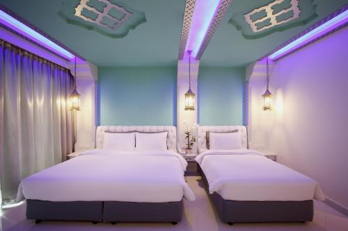two beds in a hospital room with purple lighting at The Verandah - SHA Extra Plus in Ao Nang Beach