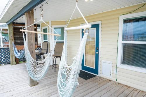 a porch with two hammocks on a house at Keepin' It Salty! in Surfside Beach