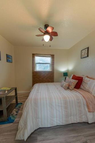 a bedroom with a bed with a ceiling fan at Keepin' It Salty! in Surfside Beach