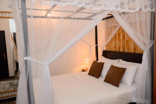 Ένα ή περισσότερα κρεβάτια σε δωμάτιο στο Almayans Bungalow