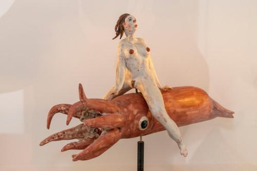 a wooden statue of a woman sitting on top of a lobster at Villa Nina in Positano