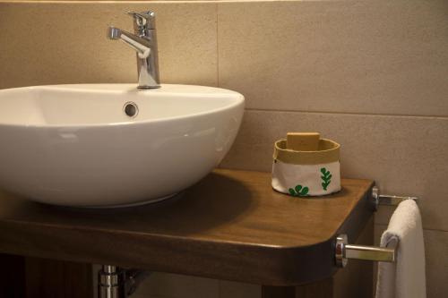 a white sink sitting on a wooden counter in a bathroom at Salamureci Camere in Trapani