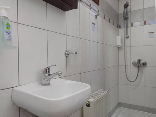 a white bathroom with a sink and a shower at Sofita Di Sofo in Kos Town