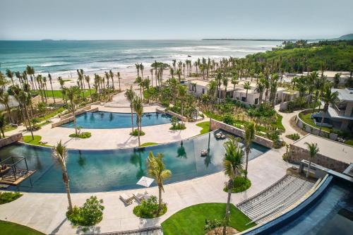 an aerial view of a resort with a pool and the ocean at Susurros del Corazón, Auberge Resorts Collection in Cruz de Huanacaxtle