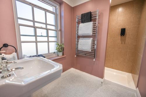 a bathroom with a sink and a shower at House Arundel in Arundel