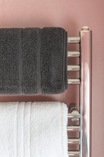 a towel rack with towels on it in a bathroom at House Arundel in Arundel