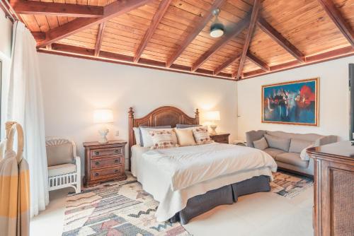 sypialnia z łóżkiem i kanapą w obiekcie Fun in the sun classic villa at Los Lagos in Casa de Campo w mieście Las Minas