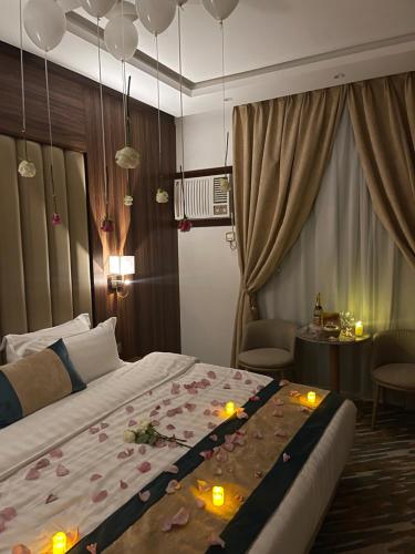 a bedroom with a large bed with flowers on it at Rawabi Garden Inn in Jeddah