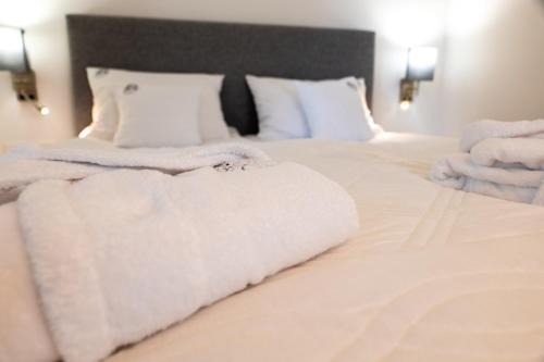 a bedroom with two beds with white towels on them at Spokojnia in Lubrza