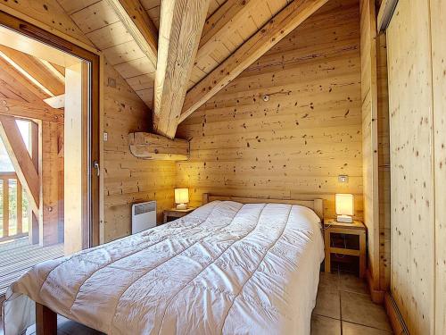 En eller flere senge i et værelse på Appart. 3 ch, proche pistes, parking privé - FR-1-416-68