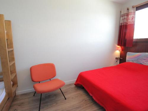 ラ・トゥッスイールにあるAppartement La Toussuire, 2 pièces, 6 personnes - FR-1-416-105のベッドルーム(赤い椅子、ベッド付)