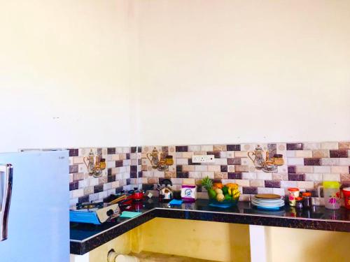 a kitchen counter with a sink and a refrigerator at st anns holiday home negombo in Negombo