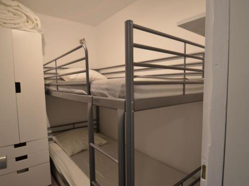 a couple of bunk beds in a small room at Studio Les Menuires, 1 pièce, 4 personnes - FR-1-452-2 in Les Menuires