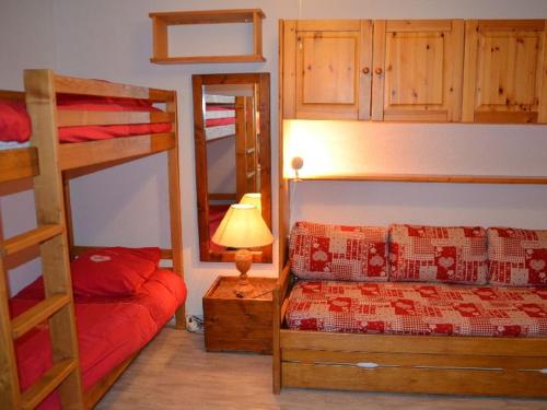 a bedroom with two bunk beds and a lamp at Appartement Les Menuires, 1 pièce, 4 personnes - FR-1-452-31 in Les Menuires