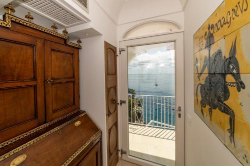 a room with a door leading to a balcony at Villa Nina in Positano