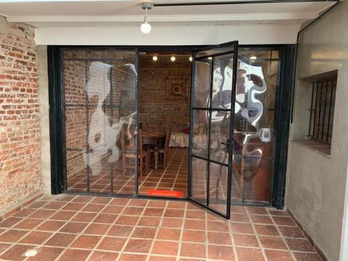 a glass door in a room with a brick wall at LO DE CAPRETTA in Almafuerte