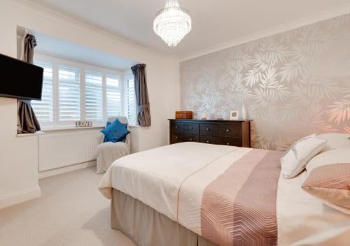 a bedroom with a large bed and a television at Vitamin Sea House in Worthing