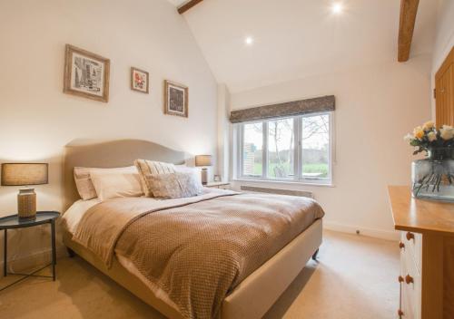 a bedroom with a large bed and a window at Little Bourne in Tonbridge