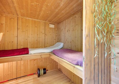 a wooden sauna with two bunk beds in it at Little Ponds in Cross in Hand
