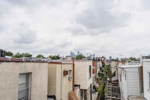 a view of the city from the roofs of buildings at Bedroom in thoughtfully decorated East Passyunk home (South Philadelphia) in Philadelphia