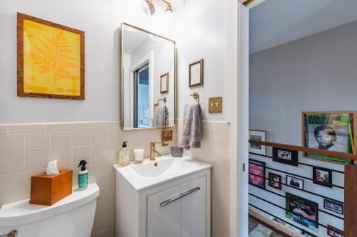 a bathroom with a sink and a mirror at Bedroom in thoughtfully decorated East Passyunk home (South Philadelphia) in Philadelphia