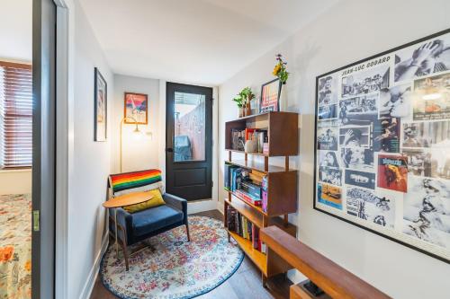 a room with a chair and a book shelf at Bedroom in thoughtfully decorated East Passyunk home (South Philadelphia) in Philadelphia