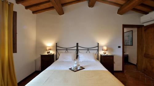 ein Schlafzimmer mit einem großen Bett mit zwei Nachttischen in der Unterkunft Villa Alessandra in Cavriglia