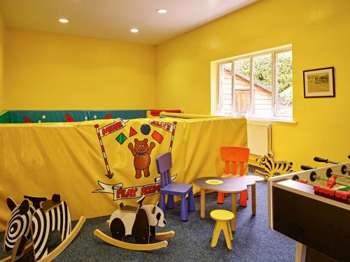 a childs room with colorful chairs and a table at Garden House in Totnes