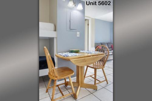 a small kitchen with a table and two chairs at Gulf Shores Plantation Condos in Gulf Shores