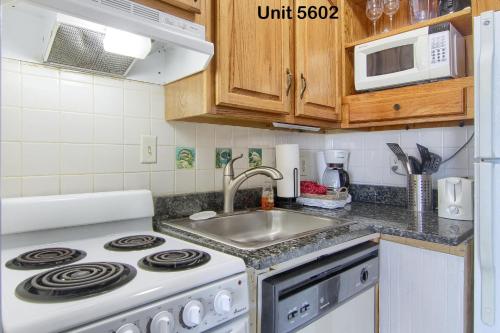 a kitchen with a stove and a sink at Gulf Shores Plantation Condos in Gulf Shores