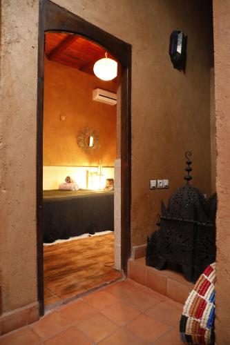 a view of a bedroom with a bed and a mirror at DAR OUZOUD Vegan in Ouzoud