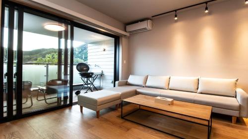 a living room with a couch and a table at Rakuten STAY MOTEL Nikko Kinugawa Garage Concept Room in Nikko