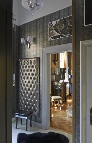 a room with a door and a living room at Boudoir Budapest Apartment in Budapest
