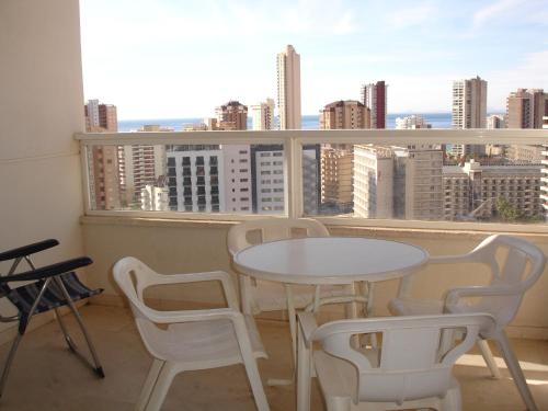 a table and chairs on a balcony with a view at Gemelos 22 - Zand Properties in Benidorm