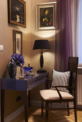 a room with a desk with a chair and a lamp at Boudoir Budapest Apartment in Budapest